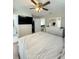 Bright bedroom with a large bed, TV, ceiling fan, ensuite bathroom and walk-in closet at 3623 N 53Rd St, Tampa, FL 33619