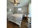 Bedroom with a large bed, wood floor, ceiling fan, dresser, and a nightstand at 3623 N 53Rd St, Tampa, FL 33619