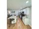 Well-lit kitchen with granite countertops, white cabinets, stainless appliances, and island seating at 3623 N 53Rd St, Tampa, FL 33619