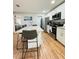 Modern kitchen featuring a granite countertop island, stainless steel appliances and wooden floor at 3623 N 53Rd St, Tampa, FL 33619