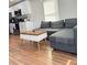 Comfortable living room featuring a stylish gray sofa and modern coffee table with wood accents at 3623 N 53Rd St, Tampa, FL 33619