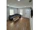 Inviting living room with a gray sectional sofa, modern coffee table, and abundant natural light at 3623 N 53Rd St, Tampa, FL 33619