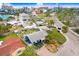 Quaint aerial view of a home nestled among mature palms in an established neighborhood near the beach at 411 Virginia Ave, Madeira Beach, FL 33708