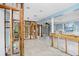 Partially renovated living room featuring exposed beams, ceiling fan, and chandelier in a spacious setting at 411 Virginia Ave, Madeira Beach, FL 33708