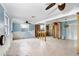 Renovated living room featuring an open layout, ceiling fans, and chandelier in a spacious setting at 411 Virginia Ave, Madeira Beach, FL 33708