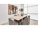 Open dining room area with wood table, seating for six, and modern light fixture and large art at 4156 Gauge Line Loop, Tampa, FL 33624