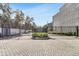 Elegant gated entrance to Gauge Lofts, with lush landscaping and brick-paved drive at 4156 Gauge Line Loop, Tampa, FL 33624