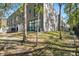 Exterior view of a modern home showcasing sleek architecture, complemented by a green lawn and mature trees at 4156 Gauge Line Loop, Tampa, FL 33624