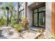 Townhome's entrance featuring a modern glass door and minimalist landscaping at 4156 Gauge Line Loop, Tampa, FL 33624