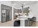 Modern kitchen featuring stainless steel appliances, gray cabinets, and a breakfast bar at 4156 Gauge Line Loop, Tampa, FL 33624