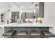 Modern kitchen featuring a quartz island with bar seating and views of the living area at 4156 Gauge Line Loop, Tampa, FL 33624