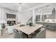 Open-concept layout featuring the dining area, living room, fireplace, and staircase, flooded with natural light at 4156 Gauge Line Loop, Tampa, FL 33624