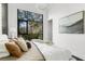 Light bedroom offers a large window overlooking trees and a comfortable bed with stylish pillows and bedding at 4156 Gauge Line Loop, Tampa, FL 33624