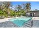 A clear in-ground swimming pool offers a refreshing escape, surrounded by greenery at 4156 Gauge Line Loop, Tampa, FL 33624