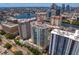 An aerial view showcasing a modern high-rise building and the cityscape at 450 Knights Run Ave # 1704, Tampa, FL 33602