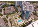 Aerial view of the property featuring a pool, lush landscaping, and surrounding buildings at 450 Knights Run Ave # 1704, Tampa, FL 33602