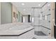 Bathroom featuring large tub with tile surround, walk-in shower with glass door, and linen closet at 450 Knights Run Ave # 1704, Tampa, FL 33602