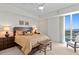 Cozy bedroom with ceiling fan, two side tables with lamps, and balcony overlooking the bay at 450 Knights Run Ave # 1704, Tampa, FL 33602