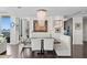 Elegant dining area features a modern chandelier, custom seating, and views of the waterfront at 450 Knights Run Ave # 1704, Tampa, FL 33602