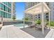 Relaxing hot tub area with lounge chairs, pergola and lush landscaping at 450 Knights Run Ave # 1704, Tampa, FL 33602