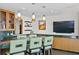 Stylish kitchen bar with green marble countertop, seating, and modern pendant lighting at 450 Knights Run Ave # 1704, Tampa, FL 33602
