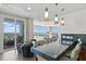 Open-concept living area with a kitchen bar, dining area, balcony access and water views at 450 Knights Run Ave # 1704, Tampa, FL 33602