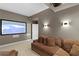 Cozy theater room features projector screen, sconces, and comfortable sofa at 450 Knights Run Ave # 1704, Tampa, FL 33602