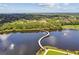 Aerial view shows the lake with the walking bridge and nearby trees at 4735 Foxshire Cir, Tampa, FL 33624