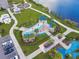 Aerial view showcases the community splash pad, grassy areas, and adjacent lake at 4735 Foxshire Cir, Tampa, FL 33624