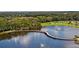 Aerial view of lake featuring a walking bridge with water features nearby at 4735 Foxshire Cir, Tampa, FL 33624