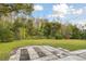 Serene backyard oasis featuring a patio area and mature landscaping at 4735 Foxshire Cir, Tampa, FL 33624