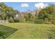 Lush backyard setting with mature trees and ample greenery, offering a private retreat at 4735 Foxshire Cir, Tampa, FL 33624