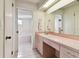 Bathroom features a large mirror, vanity, and separate tub and shower area at 4735 Foxshire Cir, Tampa, FL 33624