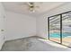 Bright bedroom featuring sliding glass doors with a view of the pool at 4735 Foxshire Cir, Tampa, FL 33624