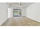 Carpeted bedroom with a ceiling fan and sliding glass door to the screened patio and pool at 4735 Foxshire Cir, Tampa, FL 33624