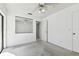 Bedroom with an adjacent room and sliding glass doors to the outside pool at 4735 Foxshire Cir, Tampa, FL 33624