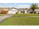 Charming single-story home with a well-manicured lawn, two car garage, and a beautiful palm tree at 4735 Foxshire Cir, Tampa, FL 33624