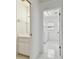 Hallway view into a bathroom and the laundry room with washer and dryer at 4735 Foxshire Cir, Tampa, FL 33624