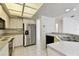 Well-lit kitchen with white cabinets, stainless steel appliances, and tile flooring at 4735 Foxshire Cir, Tampa, FL 33624