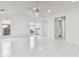 Bright living room featuring white tile flooring, recessed lighting, and multiple windows at 4735 Foxshire Cir, Tampa, FL 33624