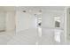 Bright living room features tile flooring, ceiling fan, and natural light from large windows at 4735 Foxshire Cir, Tampa, FL 33624