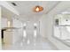Open layout featuring tile flooring, ceiling fan, and breakfast bar that connects to the kitchen at 4735 Foxshire Cir, Tampa, FL 33624