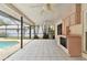Covered patio area with outdoor kitchen, built-in oven, and a view of the sparkling pool at 4735 Foxshire Cir, Tampa, FL 33624