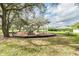 Community playground with slides and other activities surrounded by mature trees and lush green grass at 4735 Foxshire Cir, Tampa, FL 33624