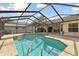 Backyard pool with screened enclosure, perfect for entertaining and relaxation at 4735 Foxshire Cir, Tampa, FL 33624