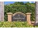Community entrance sign for Carrollwood North is surrounded by lush landscaping at 4735 Foxshire Cir, Tampa, FL 33624