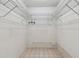 Empty walk-in closet with wire shelving and tiled floor, ready to be organized at 4735 Foxshire Cir, Tampa, FL 33624