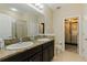 Bathroom with double vanity, granite counters, dark cabinets and shower/tub at 4739 Silverking Way, Palm Harbor, FL 34684