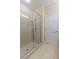 Bathroom with glass enclosed shower featuring neutral tile and large format tiles at 4739 Silverking Way, Palm Harbor, FL 34684