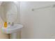A well-lit half bath features a pedestal sink with a round mirror and neutral wall color at 4739 Silverking Way, Palm Harbor, FL 34684